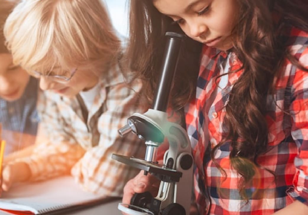 Kids looking through second-hand microscope