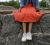 Loading placeholder for Woman sitting on a wall wearing a vintage rust floral midi skirt