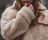 Loading placeholder for Close up of woman wearing a vintage beige fleece jacket