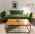 Loading placeholder for Wooden coffee table in front of green sofa