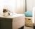 Loading placeholder for cat laying on a beige ottoman