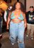 Loading placeholder for Lizzo wearing a crop top and jeans