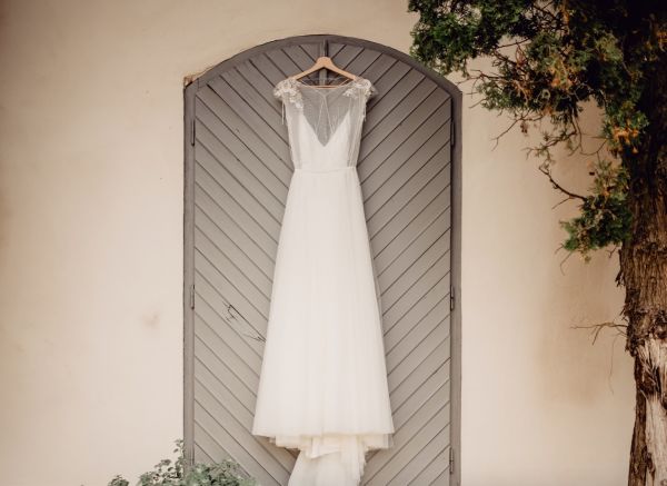 Pre loved a-line wedding dress on a hanger