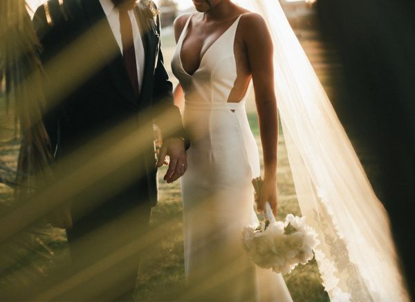 Bride wearing a sleek minimalist style pre-lived wedding dress
