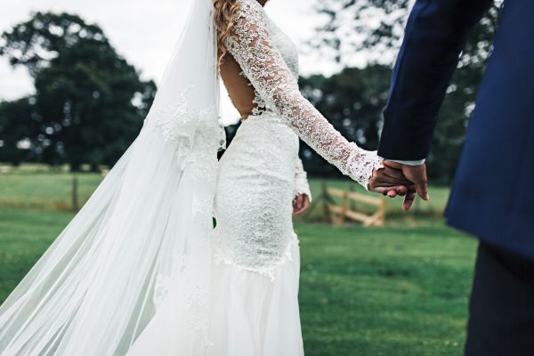 Bride wearing a vintage dress with long lace sleeves