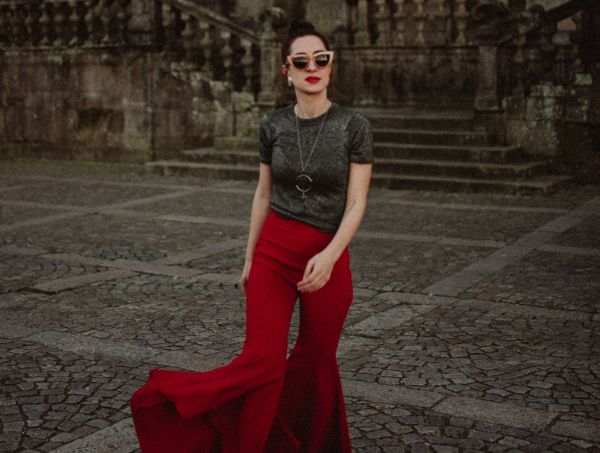 Woman wearing vintage red flares with matching red lipstick