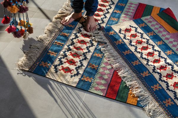 bare feet on colourful rugs