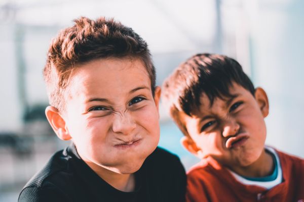 Close up of two young boys doing wacky faces