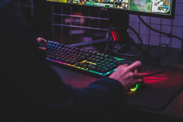 Person using desktop computer to play games