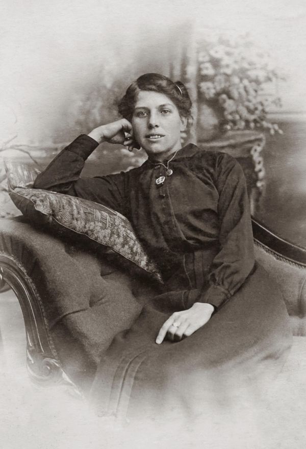 Victorian picture of a woman on a sofa looking relaxed in our guide to vintage fashion