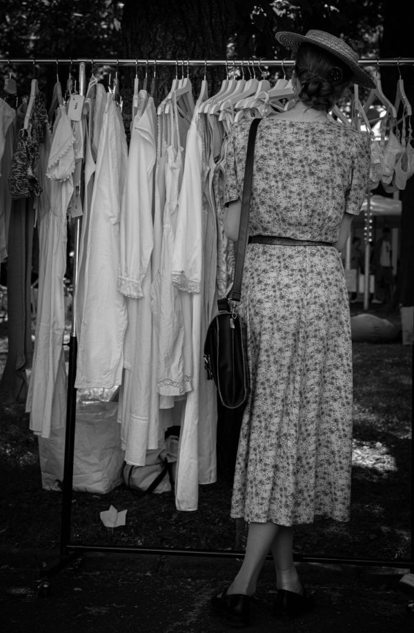 Woman in 40s tea dress shopping with her back to camera