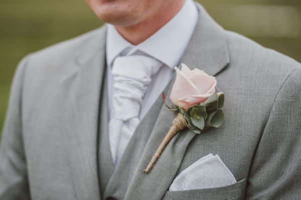 Groom wearing a grey second-hand suit and white shirt and tie