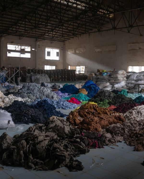 Textile waste being sorted at a recycling hub