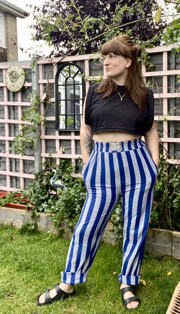 Little Splash styling striped muscle pants with a cropped black T-shirt and black sandals.