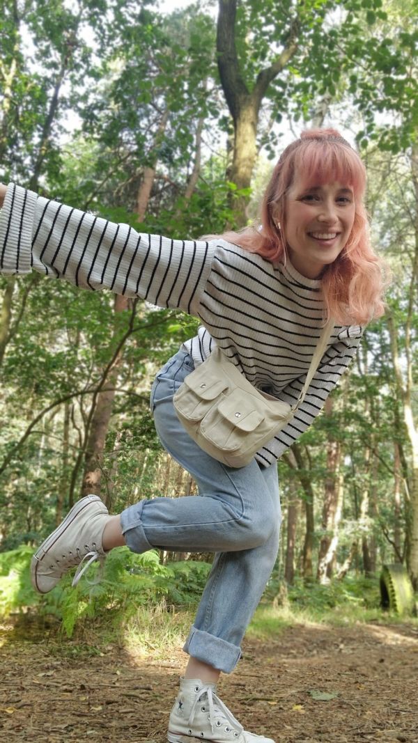 Pegz Preloved styling an oversized striped jumper with light wash mom jeans, white converse and a cream crossbody bag for a forest walk.