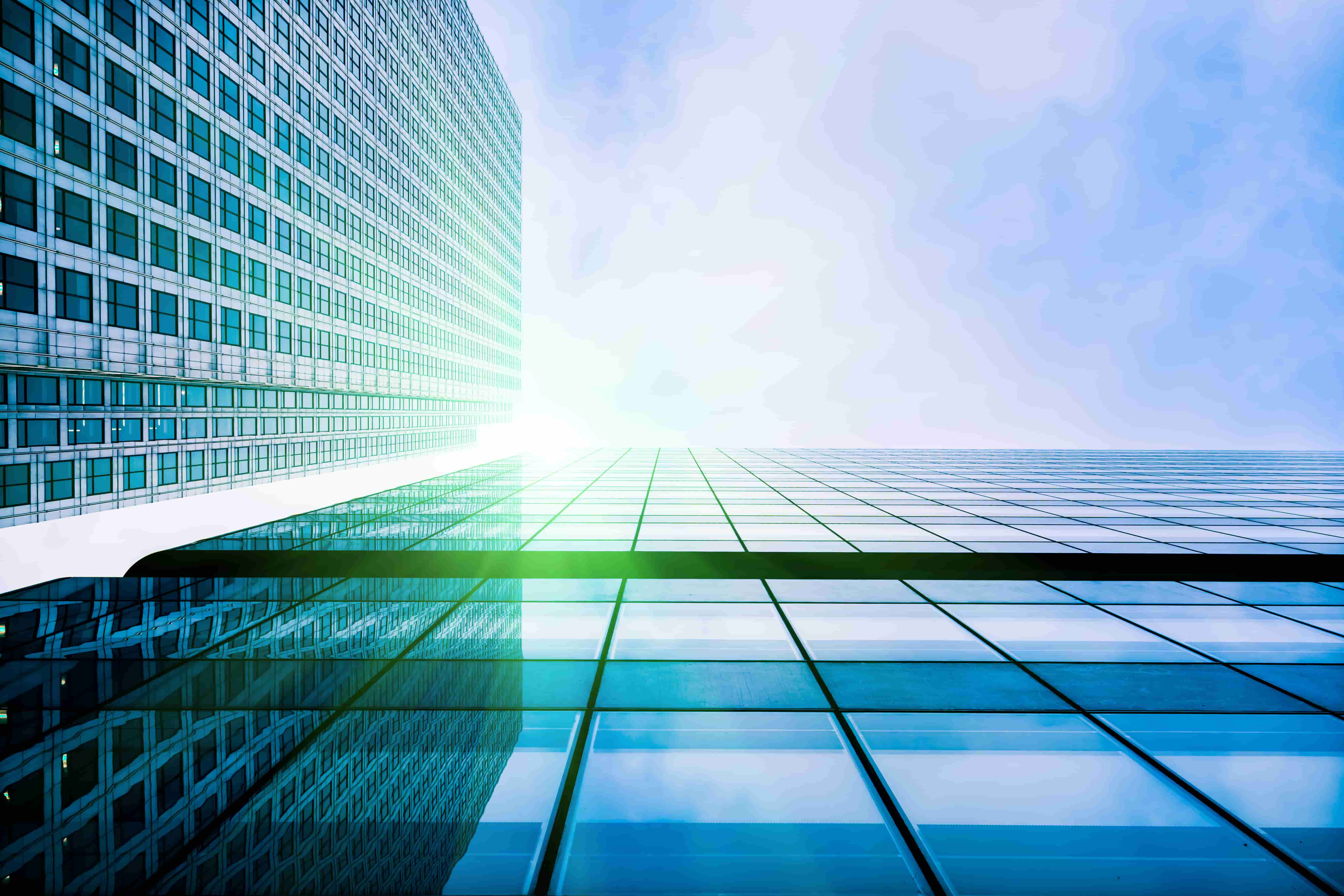 A view looking up at tall glass buildings