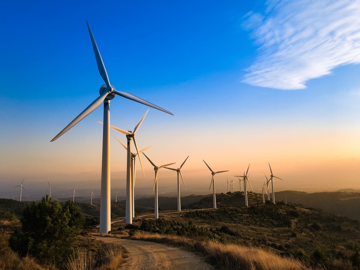 A row of wind turbines at dusk