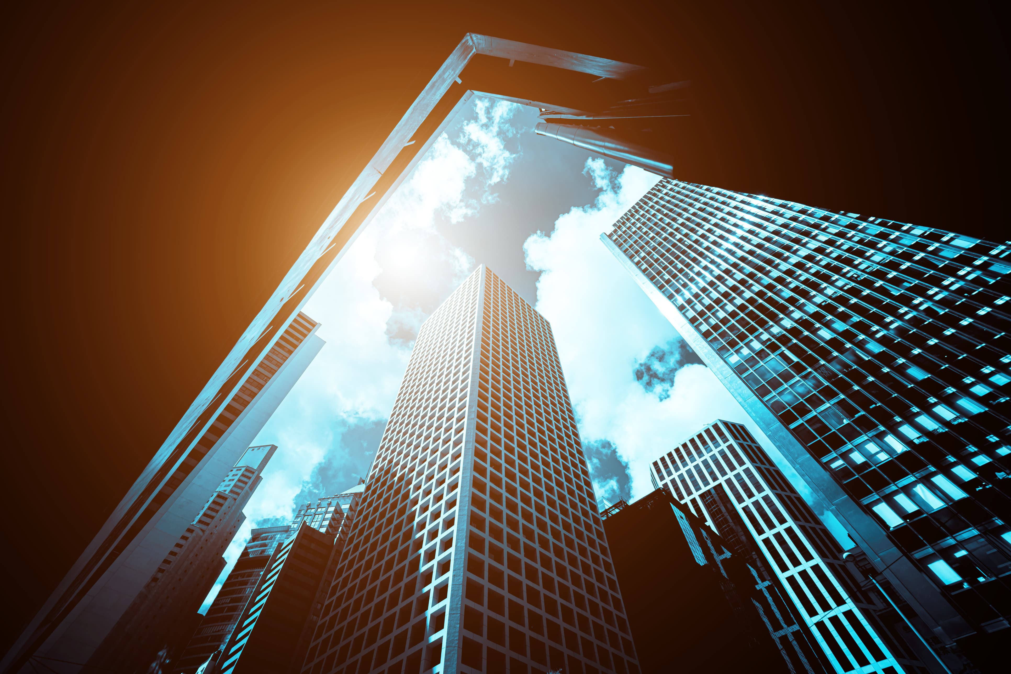 looking up at downtown buildings with bright sunny sky