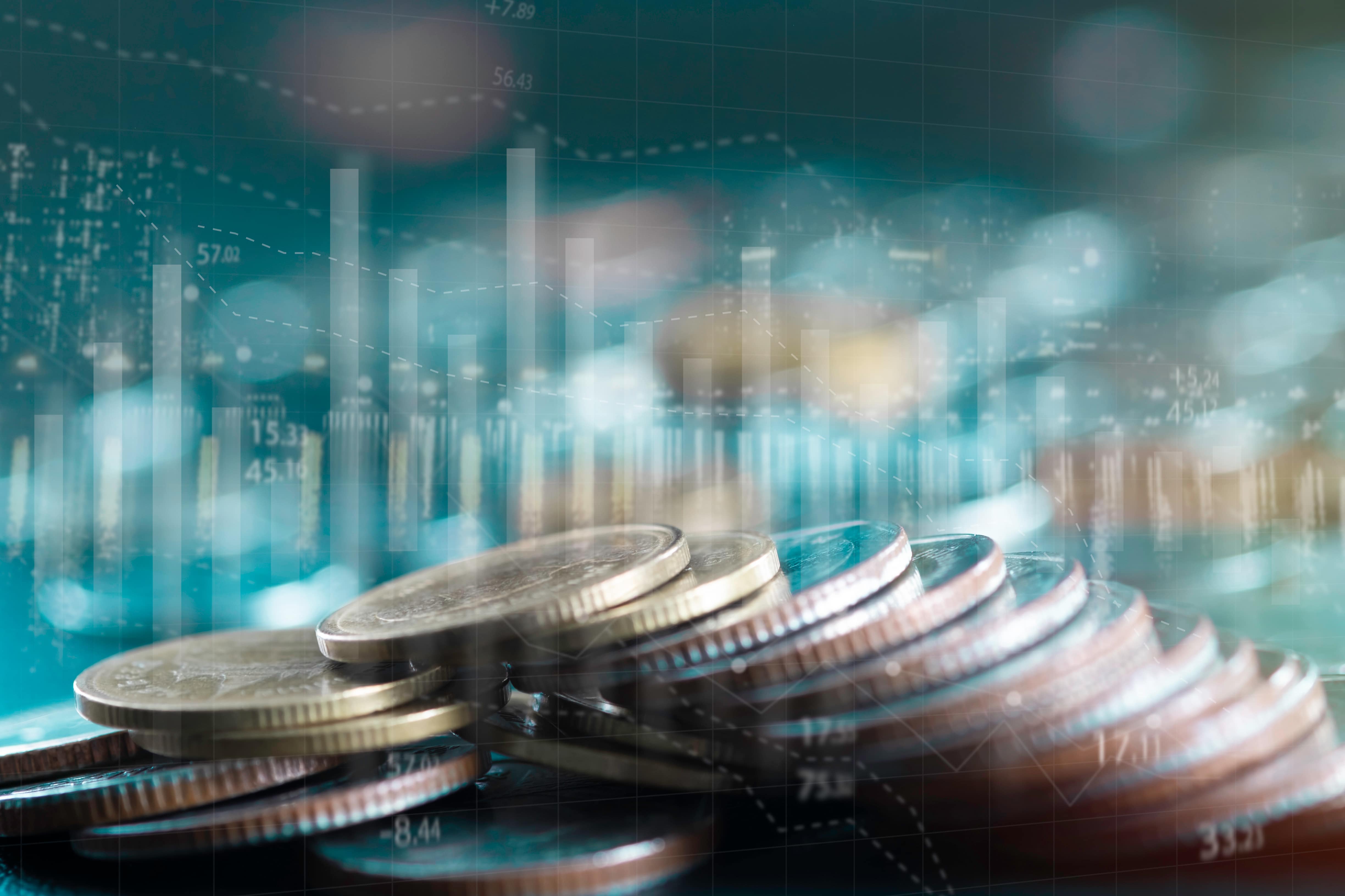 blurred coins with digital background