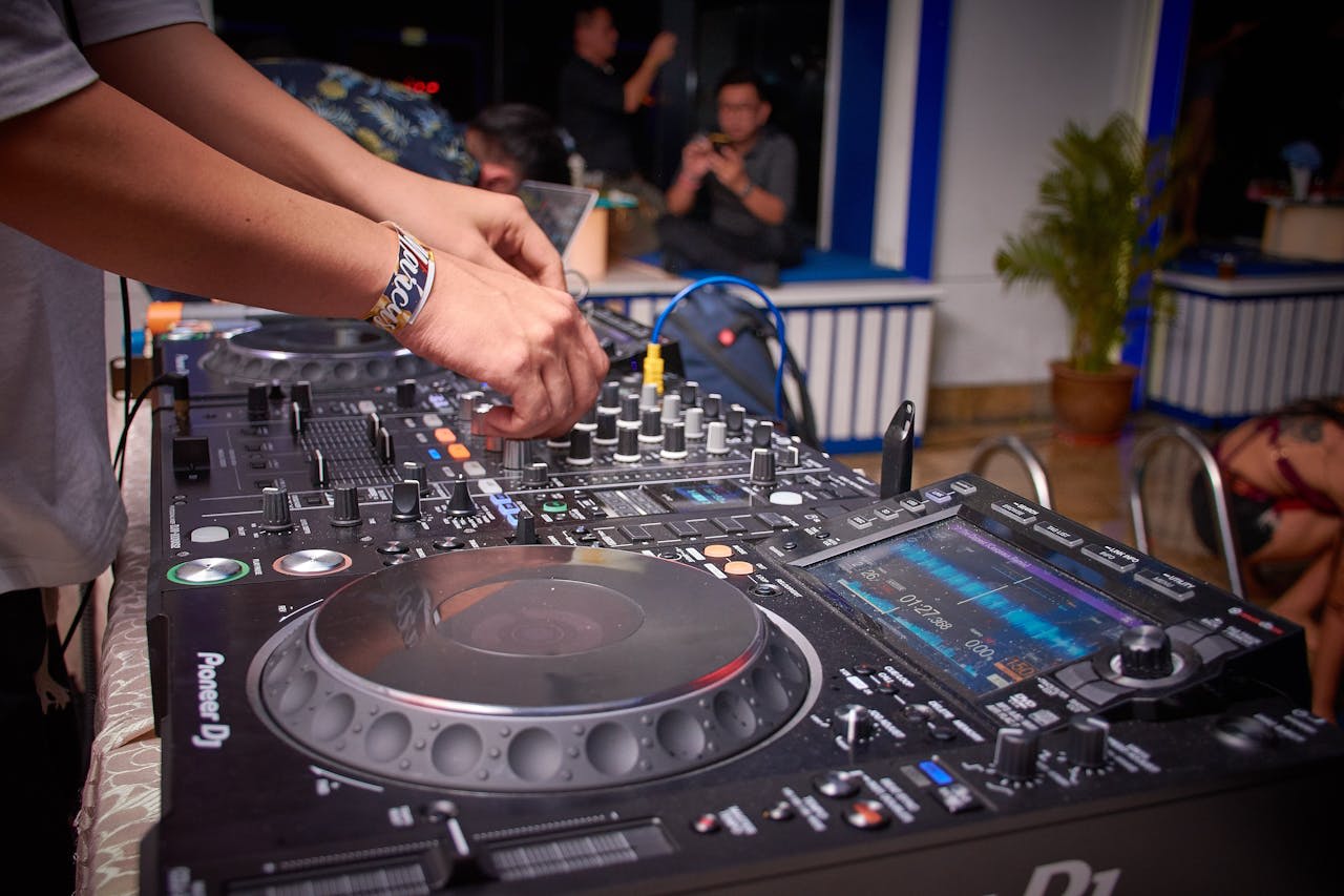 Photo by Loong Ken: https://www.pexels.com/photo/dj-playing-dj-controller-1564668/ 