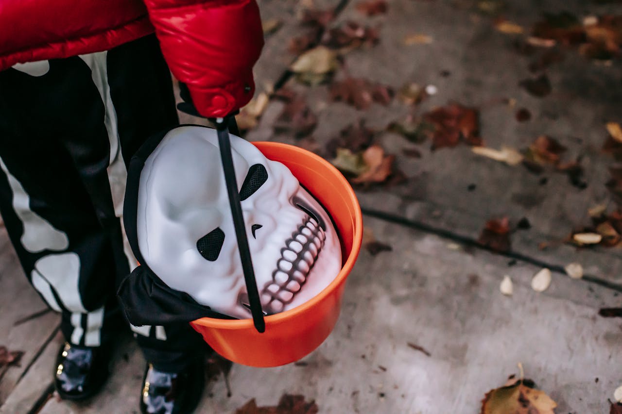 https://www.pexels.com/photo/crop-child-with-scary-mask-in-bucket-on-halloween-5859783/ 
