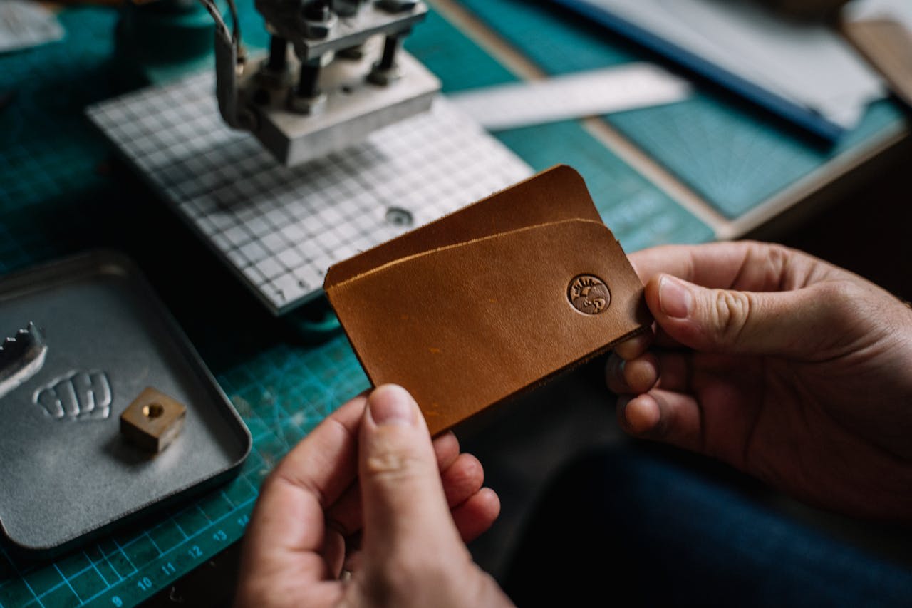 Photo by Anna Tarazevich on Pexels https://www.pexels.com/photo/person-holding-brown-leather-wallet-with-embossed-brand-logo-5963137/ 