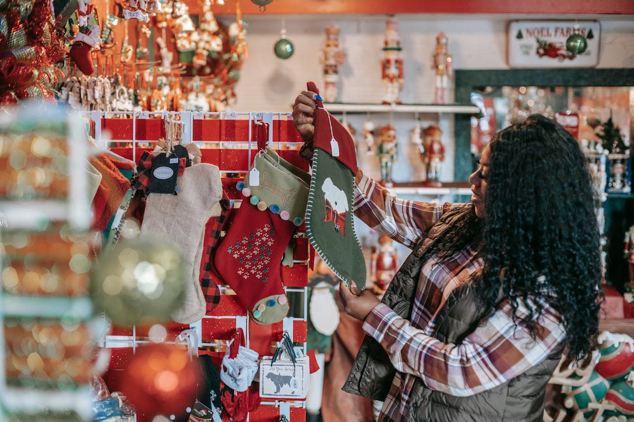 https://www.pexels.com/photo/smiling-black-woman-choosing-christmas-decorations-in-store-5728308/ Photo by Any Lane on Pexels