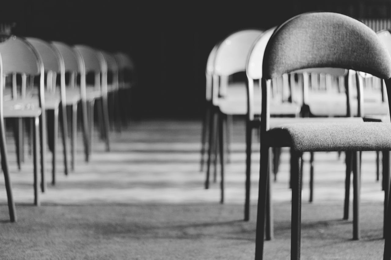 Photo by Paweł L.: https://www.pexels.com/photo/grayscale-photo-of-empty-folding-chairs-1233340/ 
