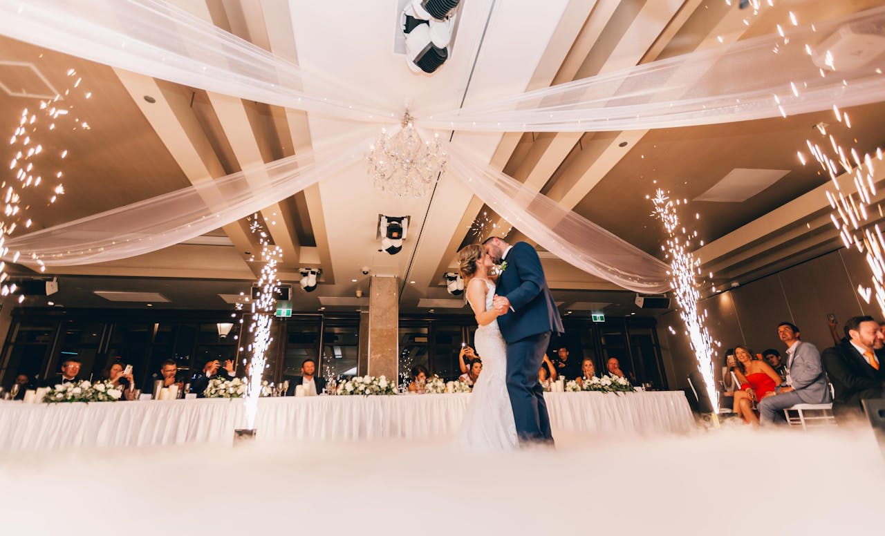 https://www.pexels.com/photo/low-angle-photography-of-bride-and-groom-dancing-3082764/ Photo by TranStudios Photography & Video on Pexels