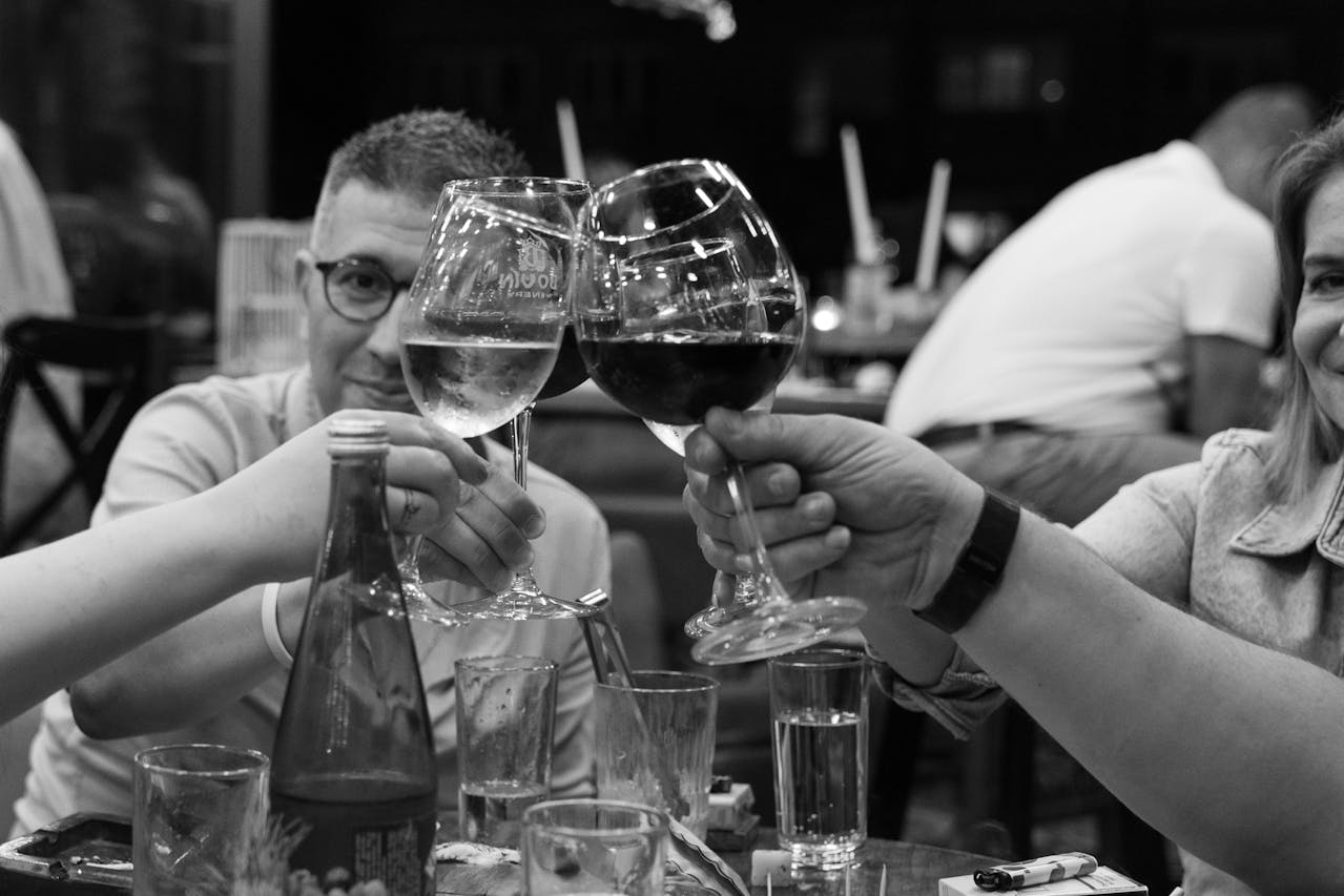 Photo by Aleksandar Andreev: https://www.pexels.com/photo/black-and-white-photo-of-a-group-of-people-clinking-glasses-25189152/ 