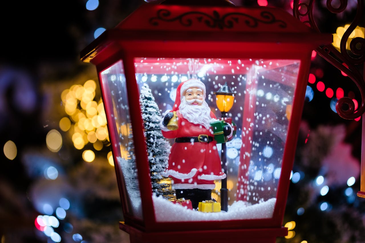 Photo by Mathias Reding on Pexels https://www.pexels.com/photo/christmas-decoration-of-santa-clause-in-a-lantern-14145379/ 