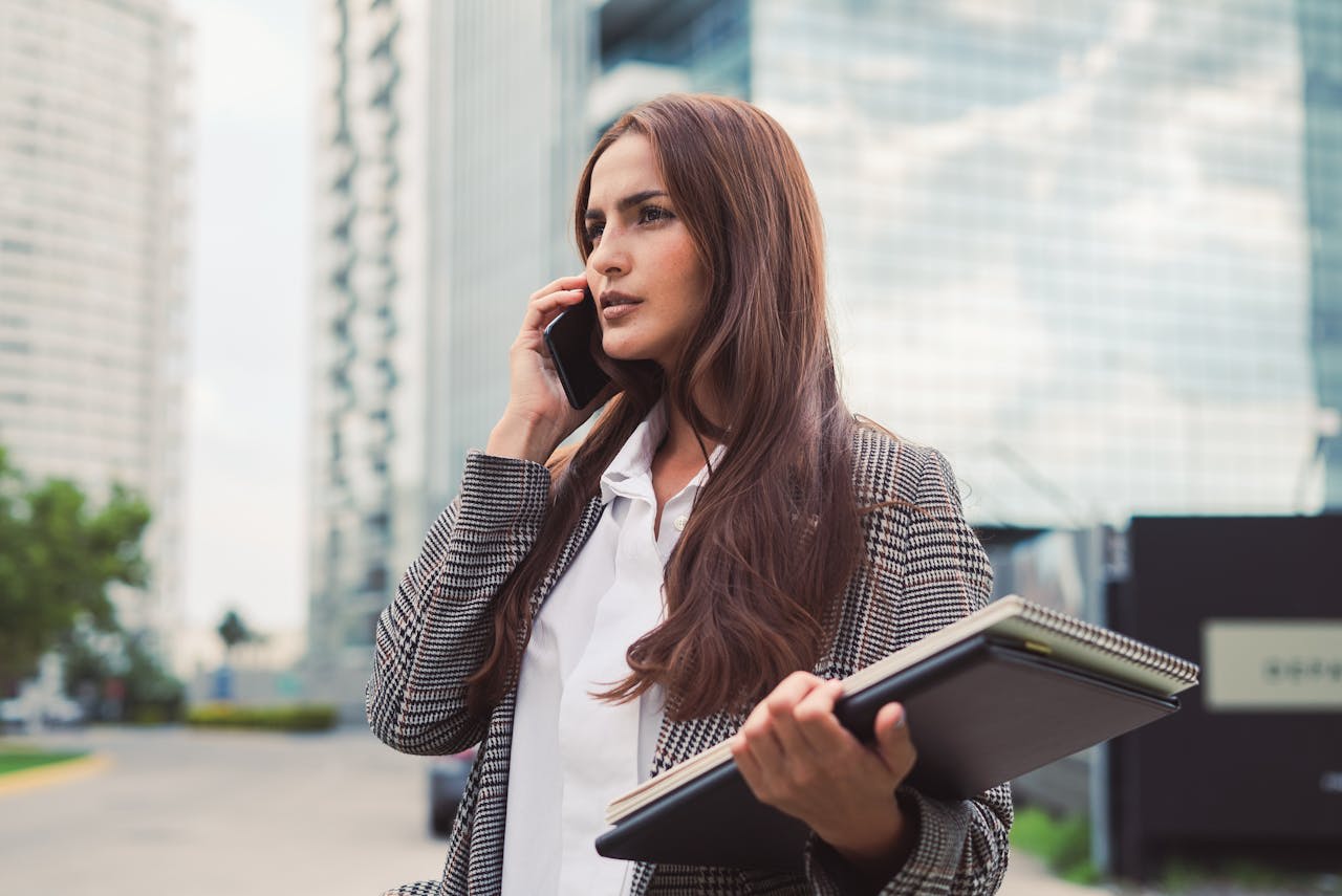 Photo by Los Muertos Crew: https://www.pexels.com/photo/portrait-of-woman-in-coat-talking-on-phone-10041284/ 