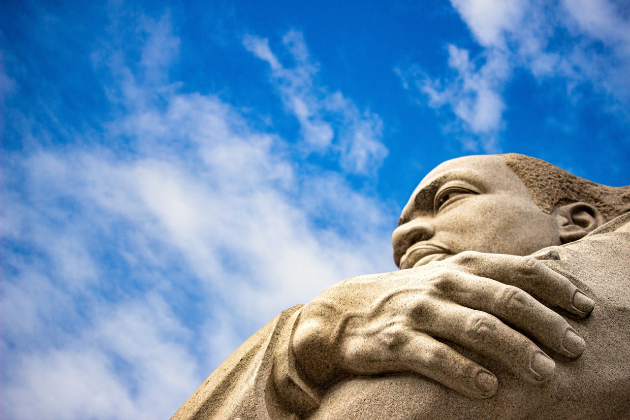 https://www.pexels.com/photo/close-up-of-granite-sculpture-of-martin-luther-king-jr-against-blue-sky-16156767/ Photo by Hugo Magalhaes on Pexels