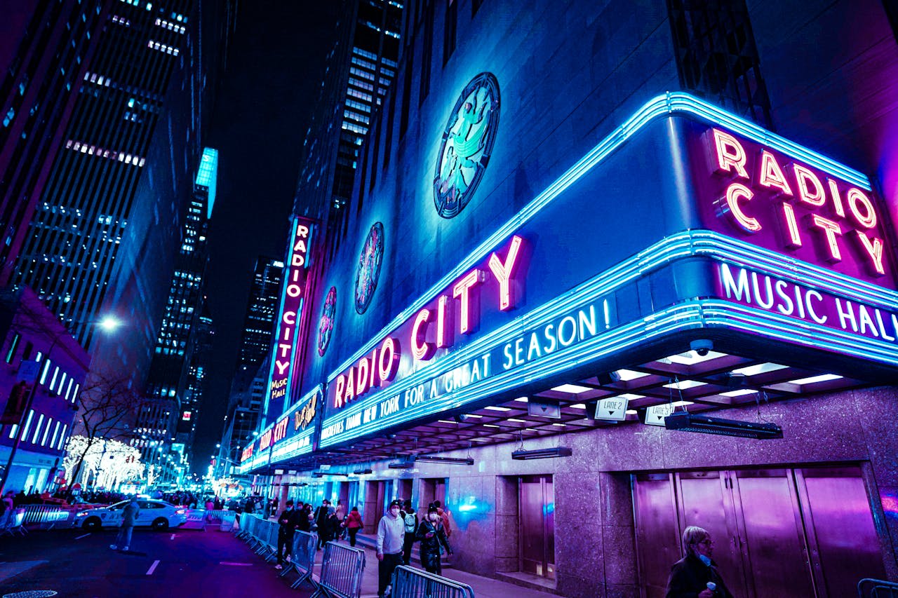 Photo by Alfred GF on Pexels https://www.pexels.com/photo/bright-lights-of-radio-city-music-hall-at-night-11534855/ 