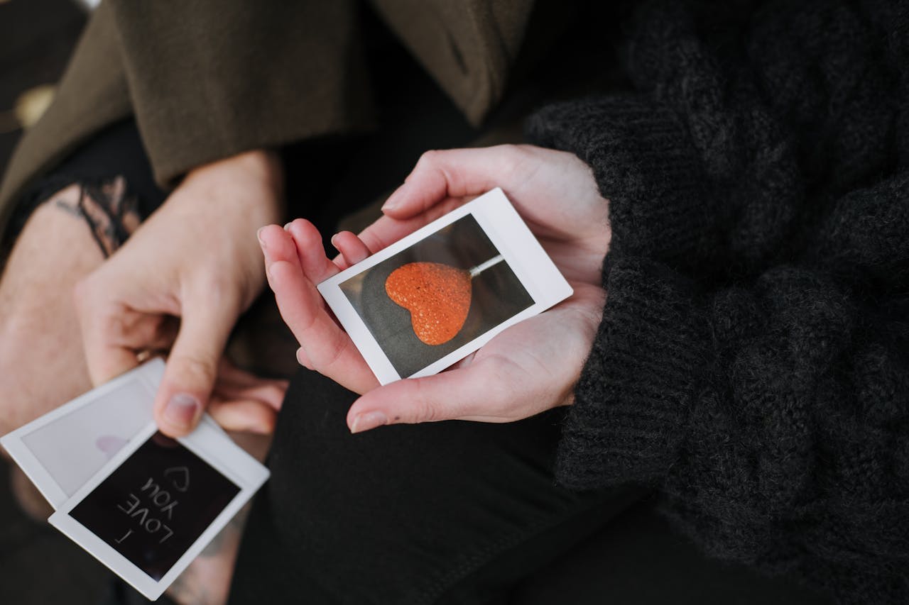 https://www.pexels.com/photo/crop-couple-with-instant-photos-5722935/  Photo by Anete Lusina on Pexels