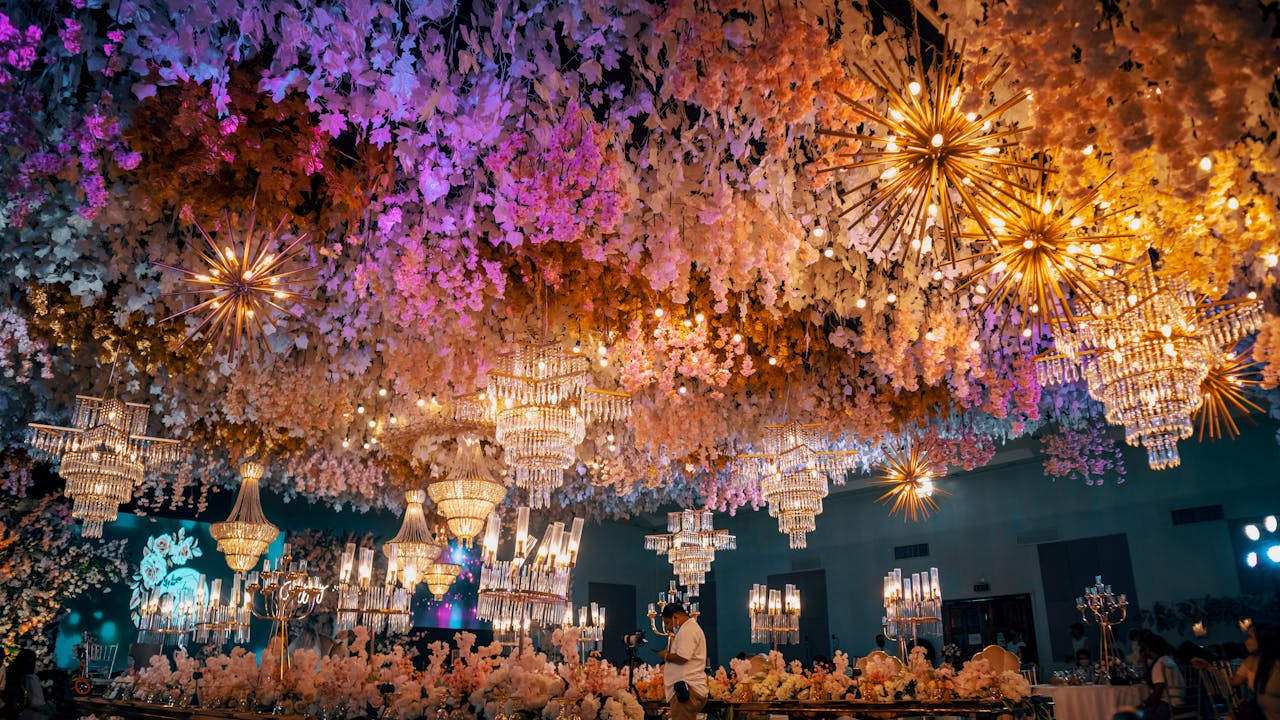 Photo by Nothing Ahead: https://www.pexels.com/photo/man-in-room-with-colorful-chandeliers-12024178/ 
