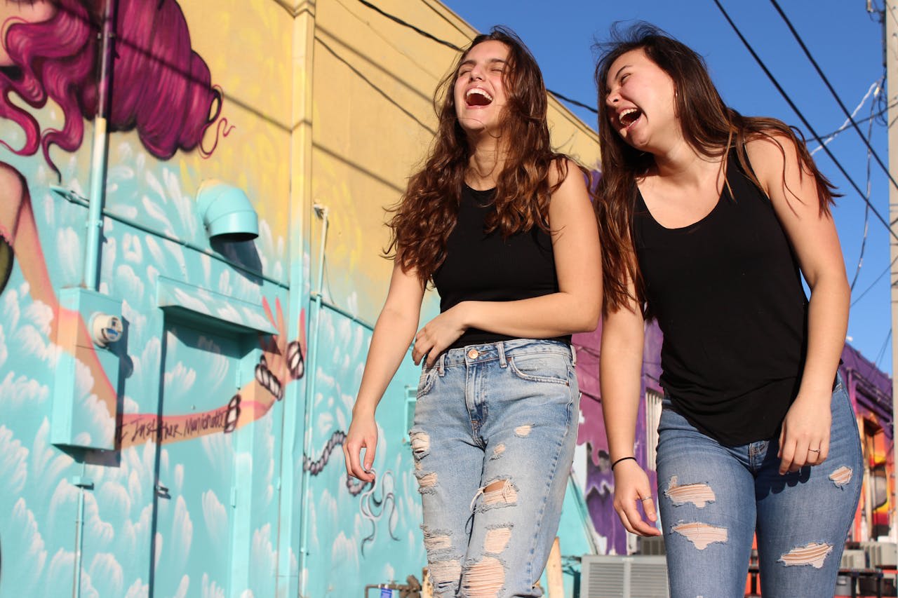 https://www.pexels.com/photo/photo-of-two-laughing-women-walking-past-graffiti-wall-2346701/  Photo by Savannah Dematteo on Pexels