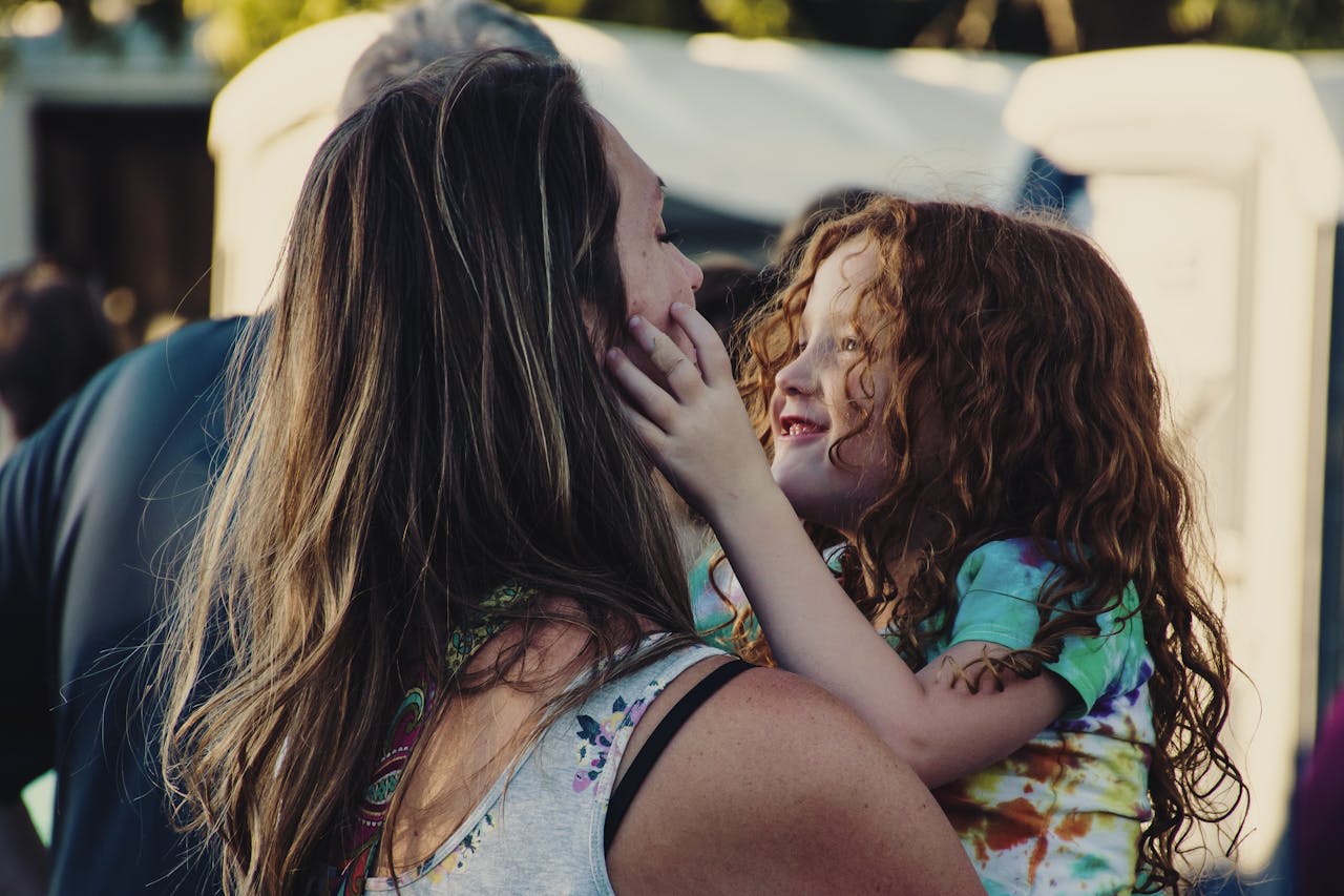 https://www.pexels.com/photo/woman-carrying-girl-while-showing-smile-1445704/  Photo by Brett Sayles on Pexels
