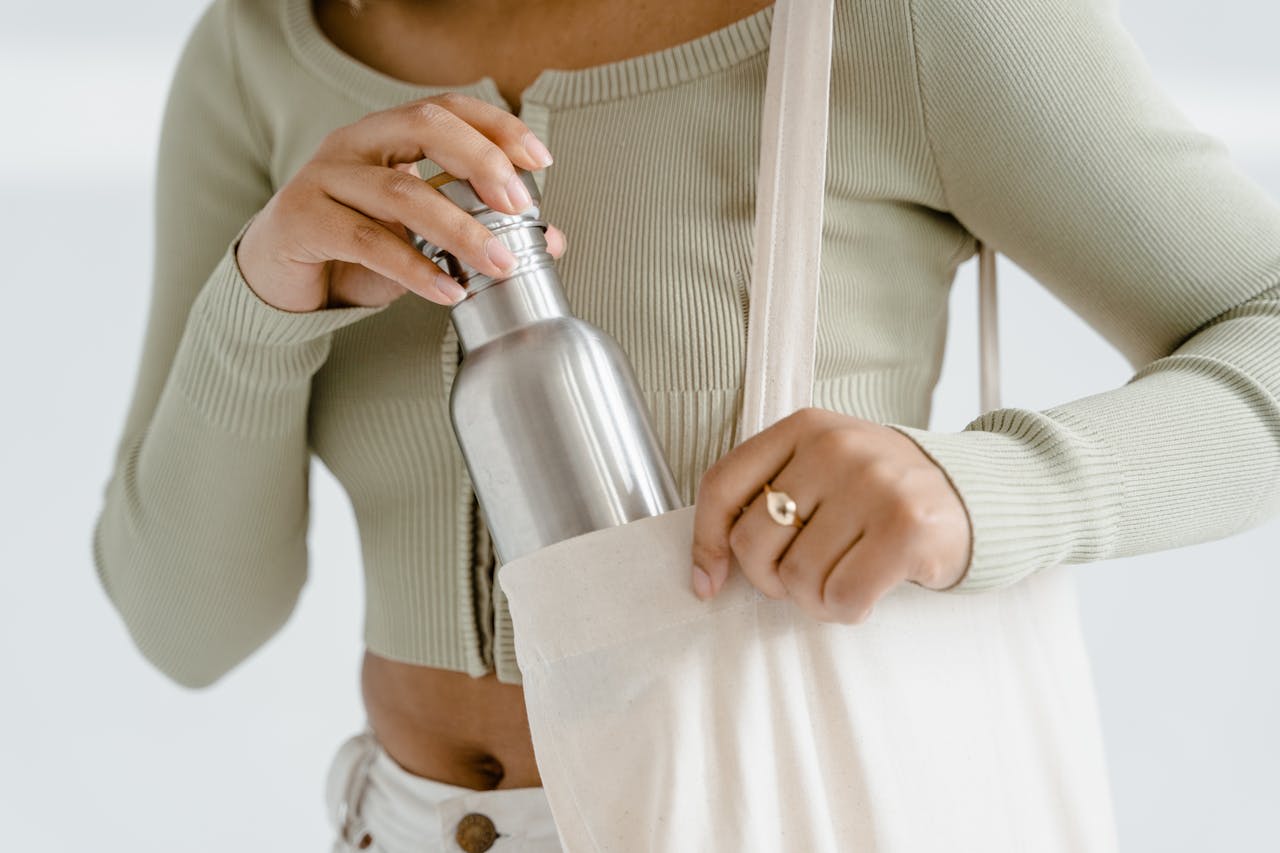 Photo by Tima Miroshnichenko: https://www.pexels.com/photo/a-person-in-gray-crop-top-holding-stainless-tumbler-7879796/ 
