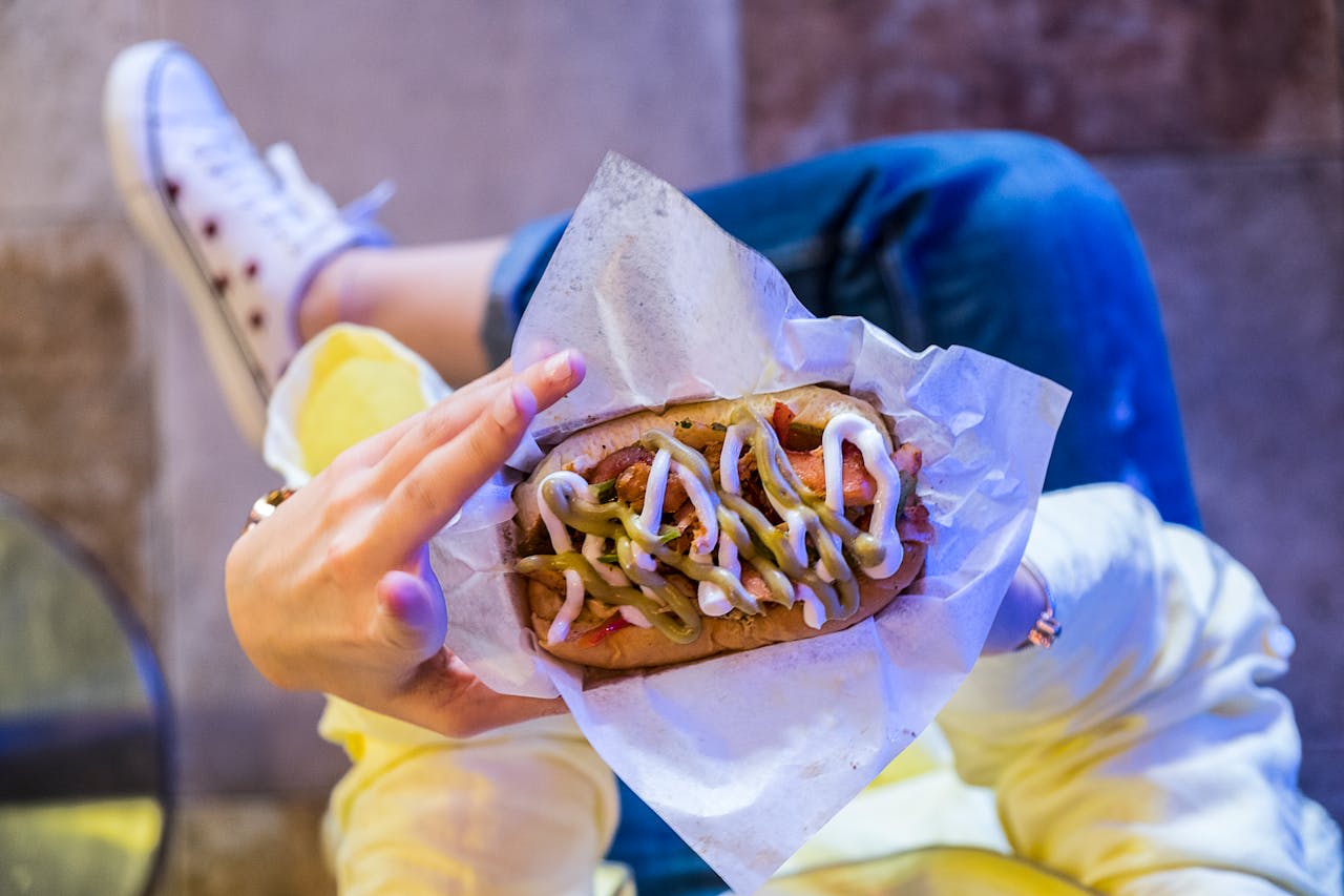 Photo by The Lazy Artist Gallery: https://www.pexels.com/photo/woman-holding-burger-1390940/ 