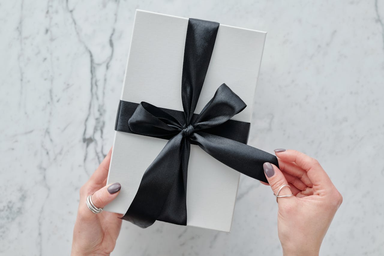 https://www.pexels.com/photo/person-holding-white-and-black-gift-box-5872179/  Photo by Max Fischer on Pexels 