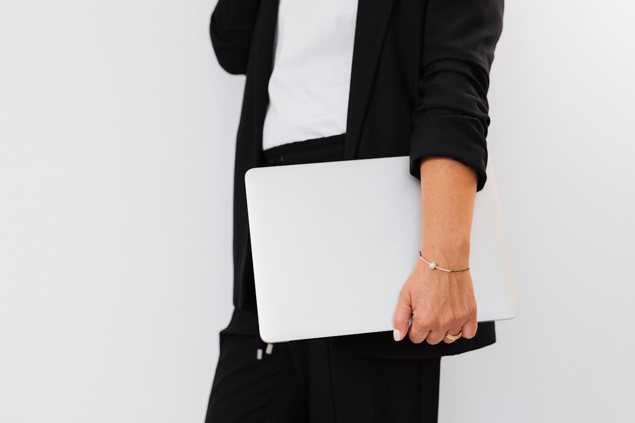 Photo by Photo By: Kaboompics.com: https://www.pexels.com/photo/hand-carrying-a-laptop-5240175/ 
