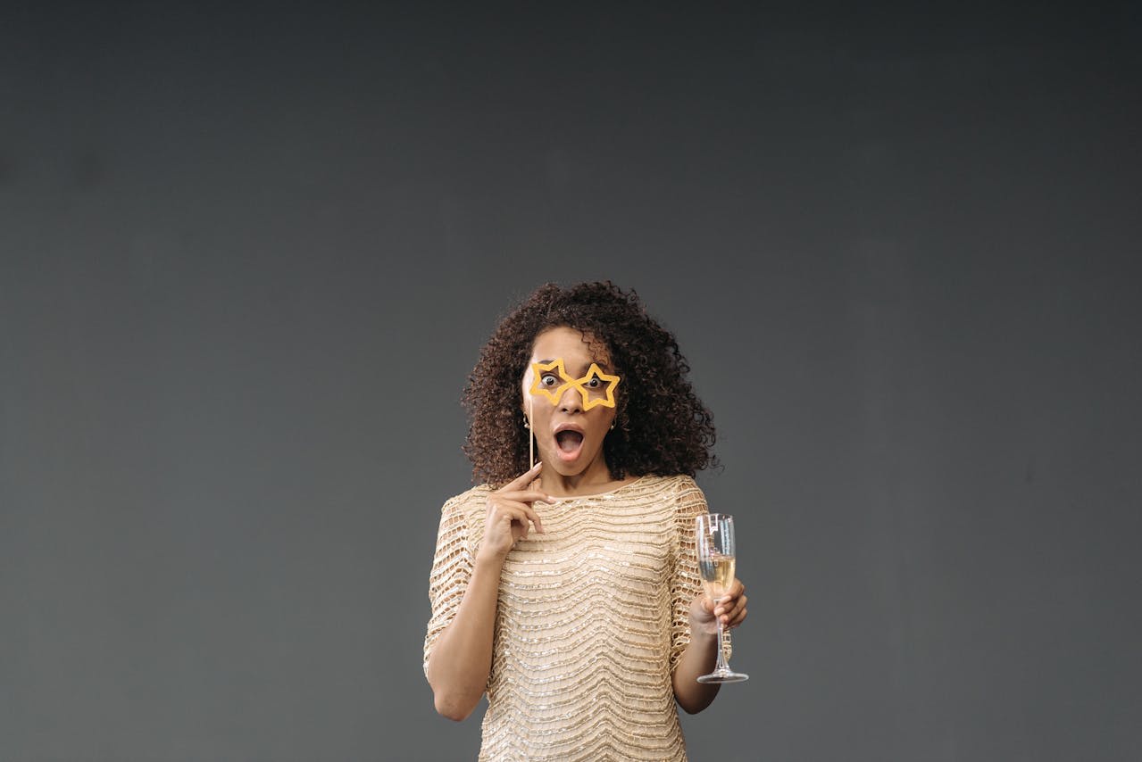 Photo by Pavel Danilyuk: https://www.pexels.com/photo/surprised-woman-holding-glass-of-champagne-6405834/ 