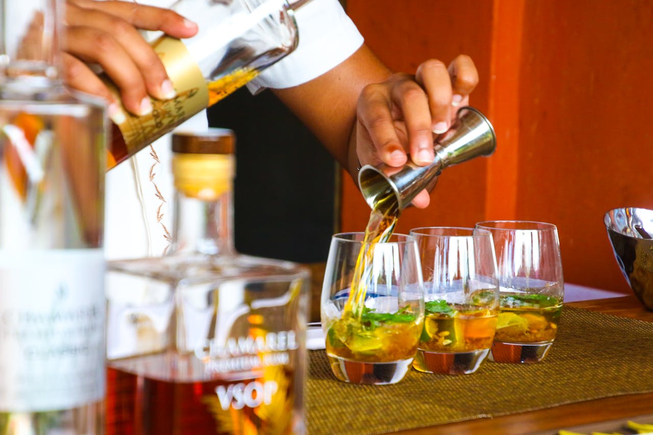 Photo by Magda Ehlers: https://www.pexels.com/photo/person-poring-cocktail-on-clear-drinking-glass-1189257/