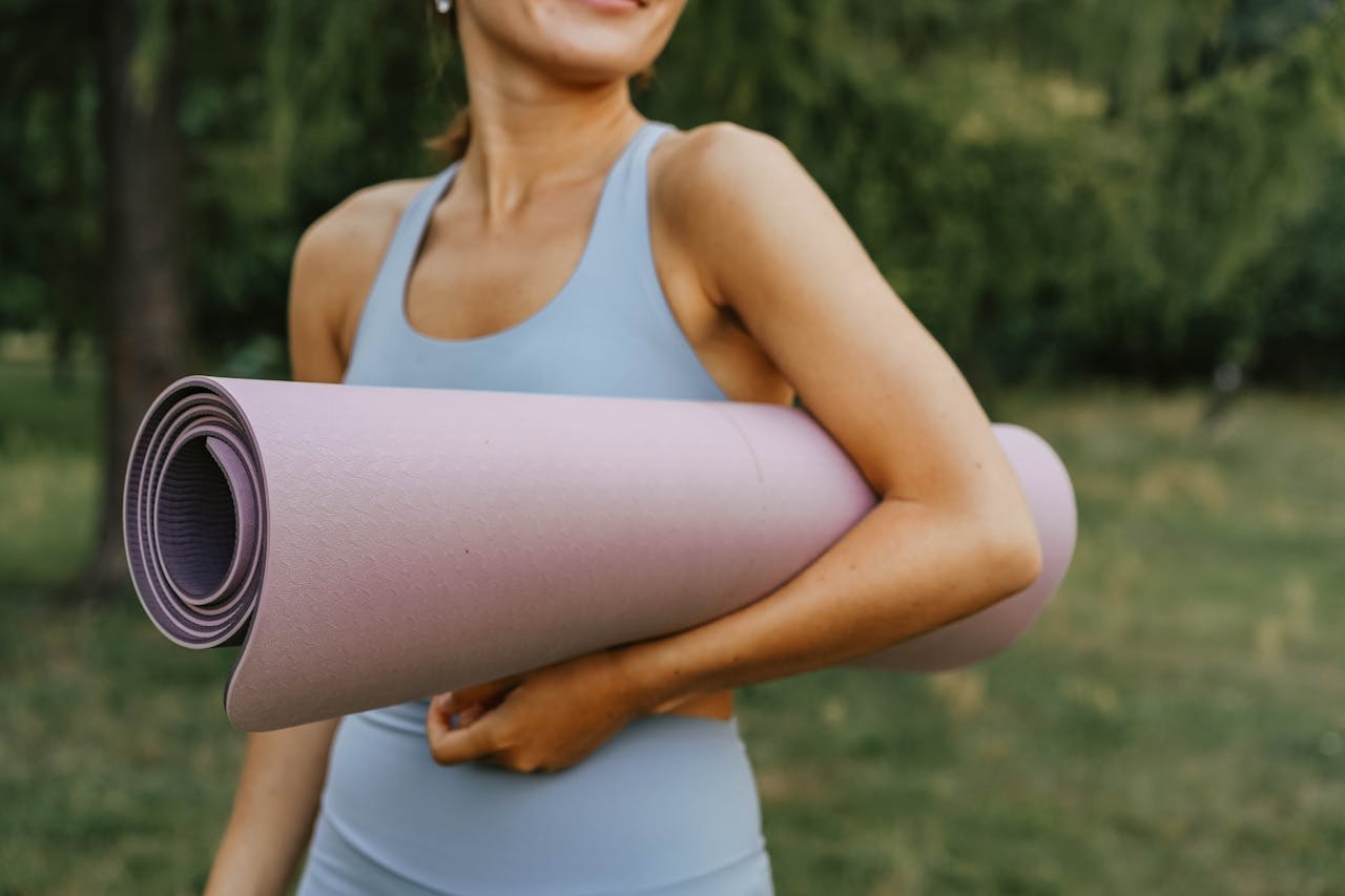 Photo by olia danilevich: https://www.pexels.com/photo/a-person-in-blue-tank-top-holding-rolled-yoga-mat-9004302/ 