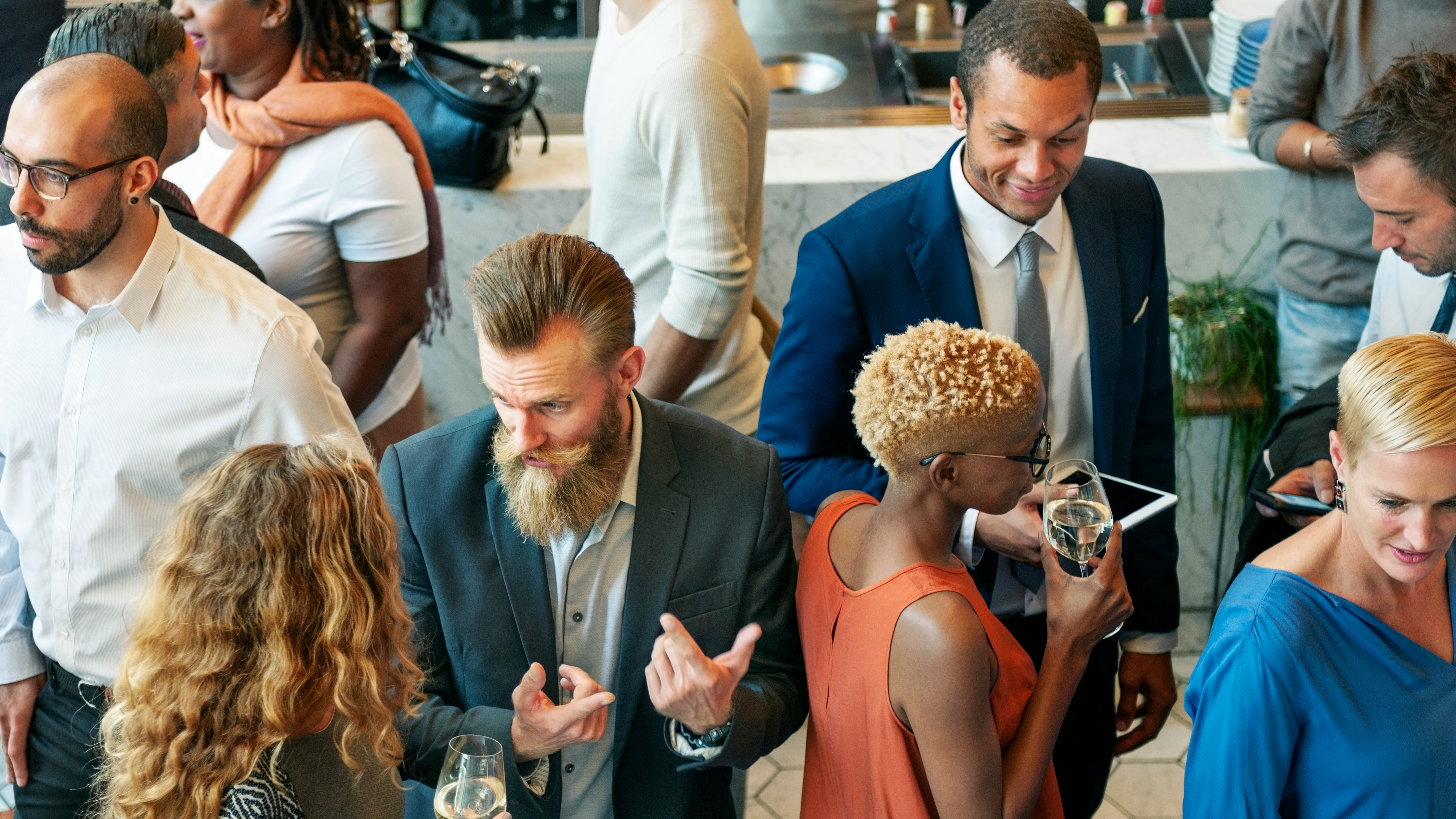https://unsplash.com/photos/a-group-of-people-standing-around-each-other-Tc1mBpMS-zs