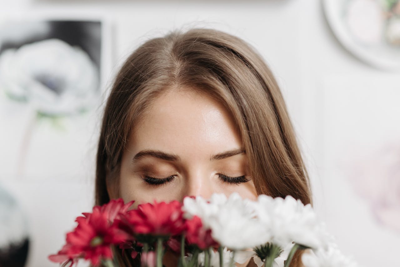 Photo by Pavel Danilyuk: https://www.pexels.com/photo/a-woman-with-her-eyes-closed-smelling-flowers-6925631/