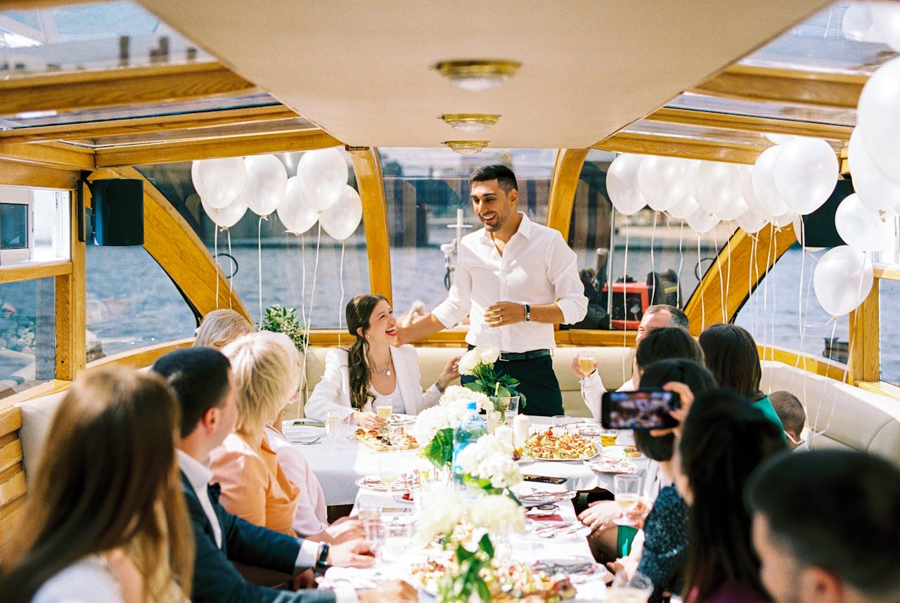 Photo by Vladimir Konoplev : https://www.pexels.com/photo/grooms-wedding-speech-to-guests-on-boat-10955585/