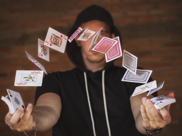 https://unsplash.com/photos/woman-in-black-and-white-crew-neck-t-shirt-holding-playing-cards-YlgnX_ISPLo