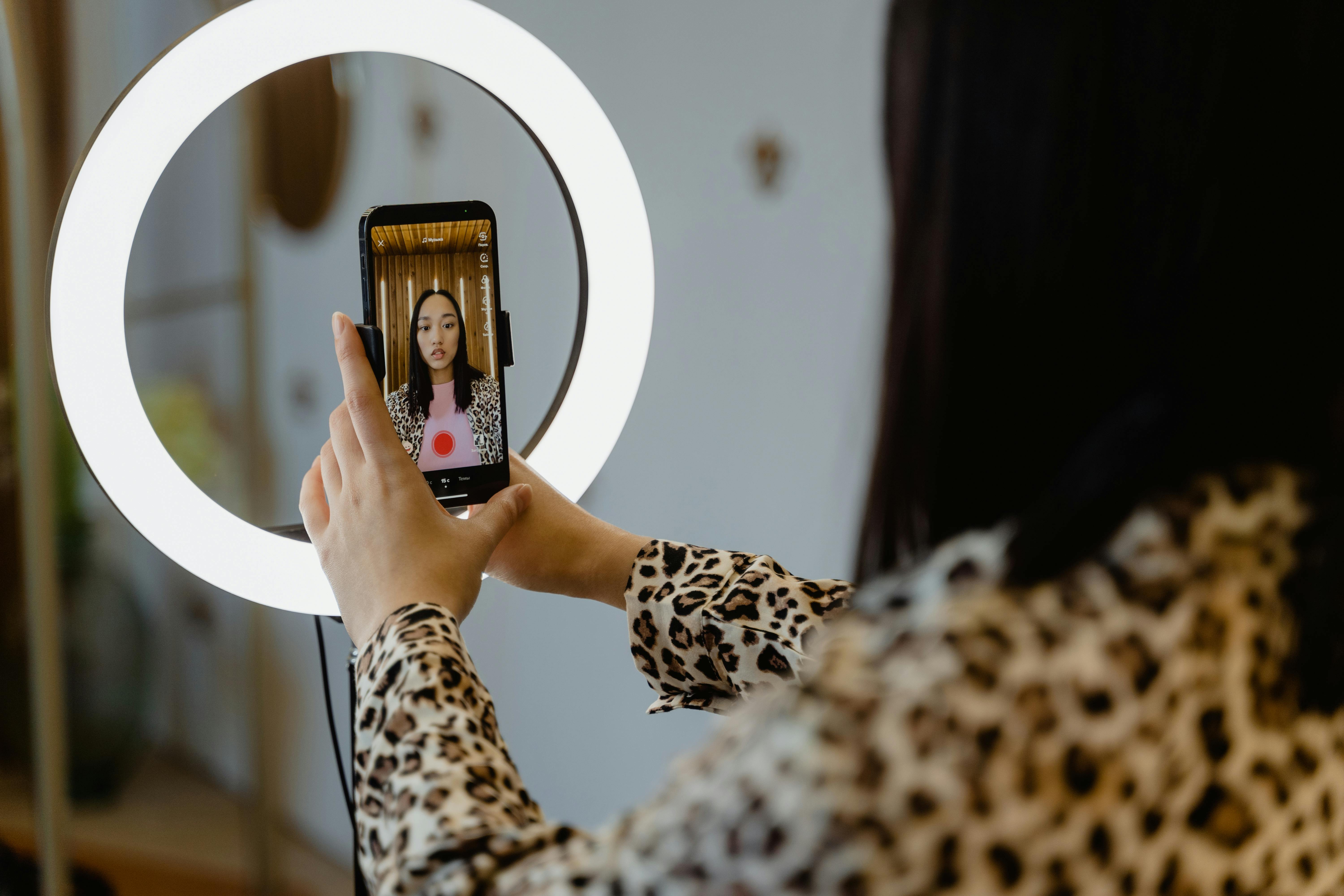 Photo by MART  PRODUCTION: https://www.pexels.com/photo/a-woman-using-smartphone-and-ring-light-7480538/